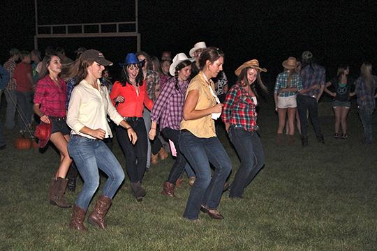 Ms. Korinn Schriver teaches a country line dance to Katherine Kircher, Claire McCullough, Maria Ambrosy, Cindy Stierman, and Elena Dominguez at the schools first Hoedown.