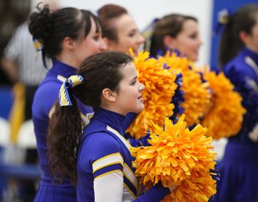 Bridget Sullivan, 16, cheers on the Eagles during the first quarter of the Wahlert-Senior game at the Colbert-Delaney Gymnasium. Sullivan has been a part of the cheerleading team since the start of her freshman year.