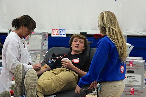 BLEEDING LOVE Student Senate members Will McDonald and Maddie Heiar do their part for the fall blood drive. The drive is only one of the many activities that the Student Senate coordinates.