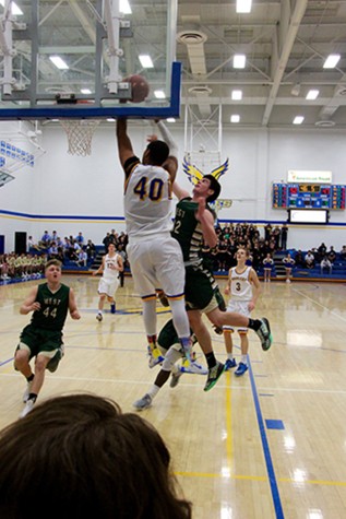 Making a statement Cordell Pemsl, '16, dunks the basketball during a home game against Iowa City West. The Eagles won the game, 74-68.