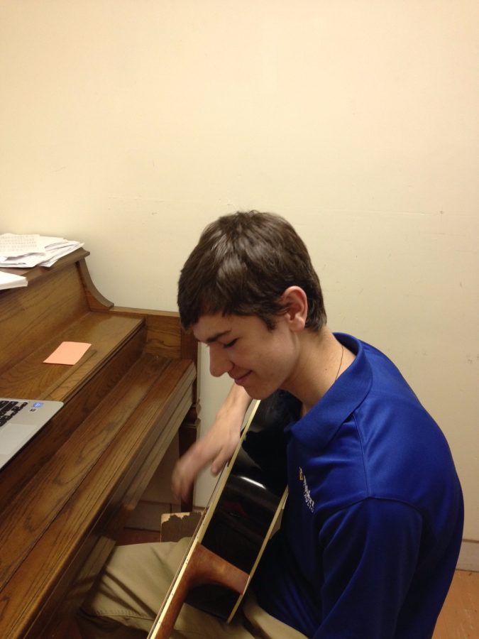 Carson Kunkel, 18, jamming out on his guitar.
