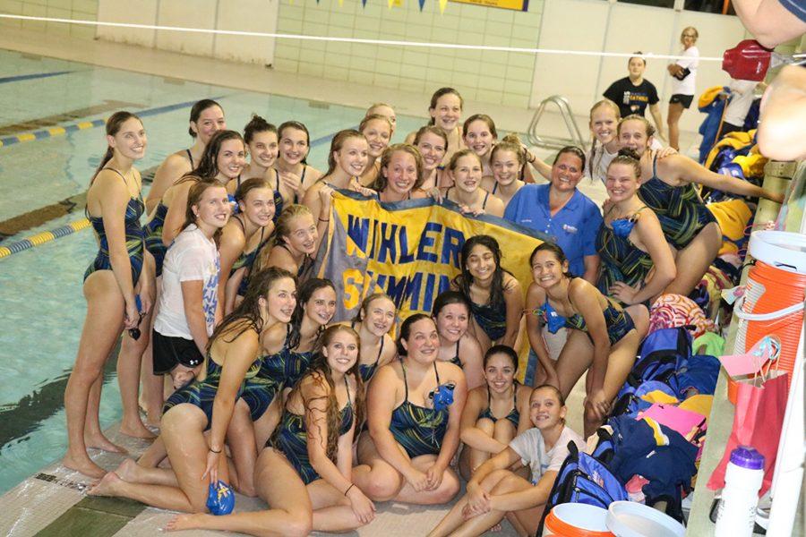 Wahlert womens swim team celebrates after successful meet.
