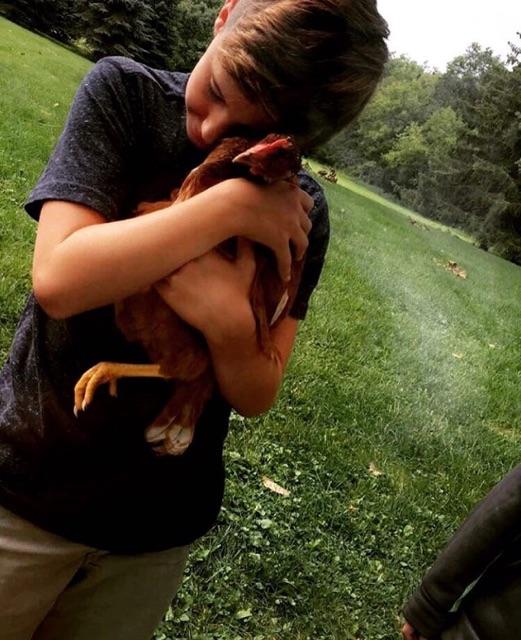 Peckoshs younger brother, TJ, with Penny the hen. TJ attends Mazzuchelli Middle School. 