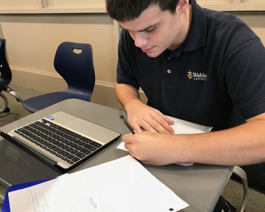 Sam Kluesner, 20, writes his biology homework in cursive handwriting.
