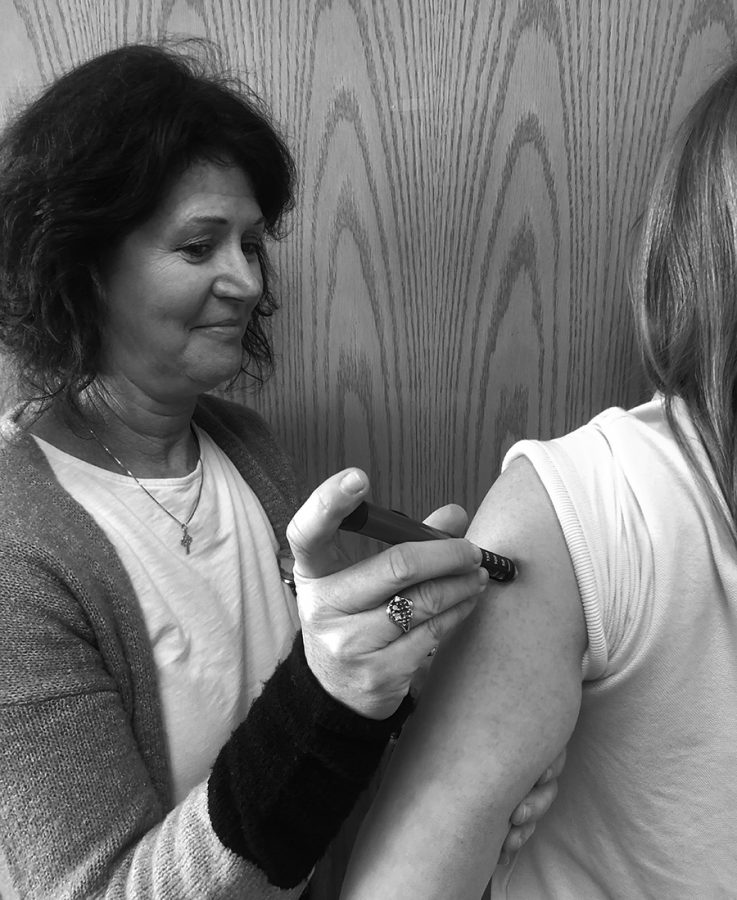 Holy Family Catholic School nurse, Beth Broderick, demonstrates a insulin shot. 
