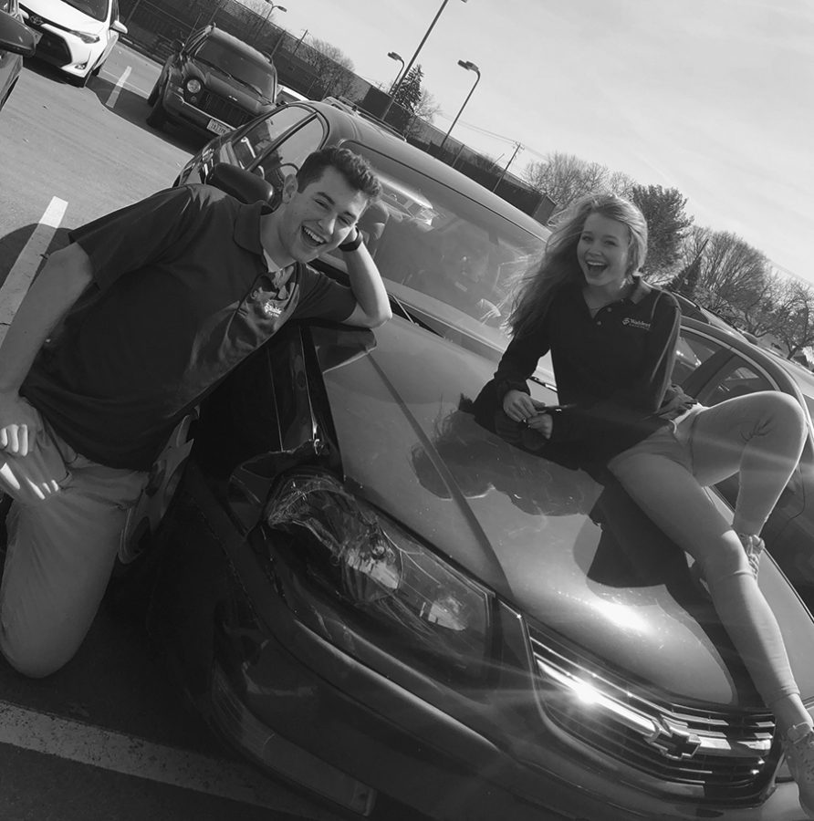 Tanner Rudiger and Klara Strand, 20, laugh while lounging on top of his car after school during the brief glimpse of summer weather.