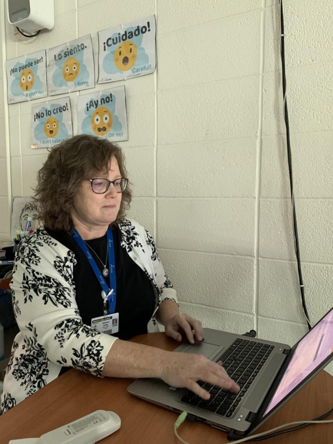 Mrs. Becky Varley enters grades into PowerSchool before meeting with parents this week. 