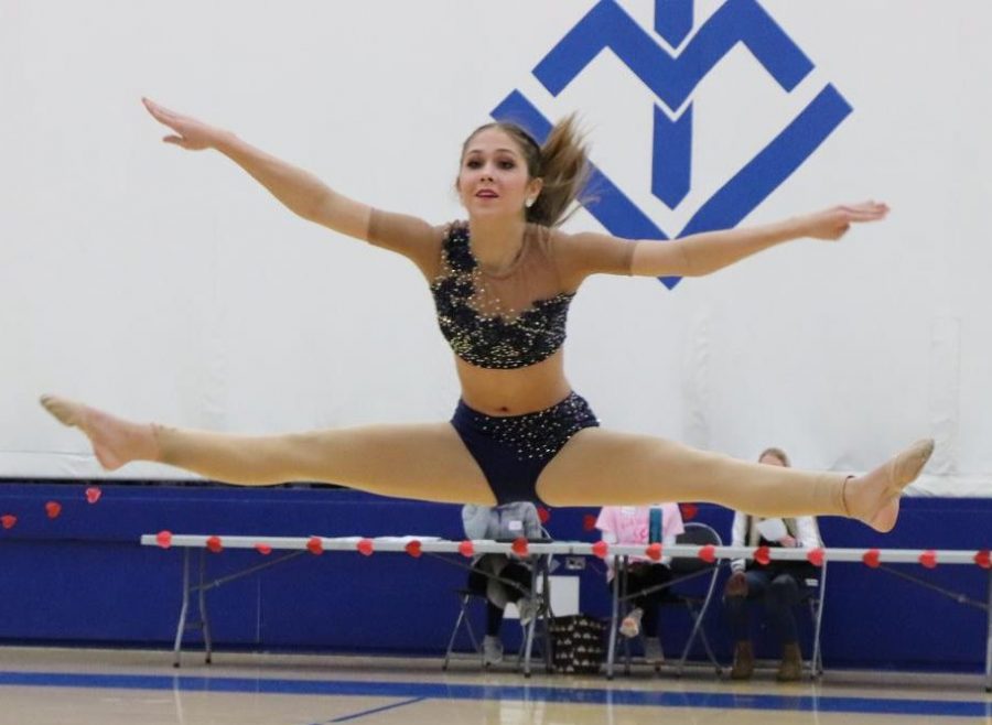 Lizzie Kann, 22, performs a solo routine during the Rock the Rafters showcase, which featured performances from various dance studios, Senior High color guard, and individuals, as well as the Wahlert Dance Team.
