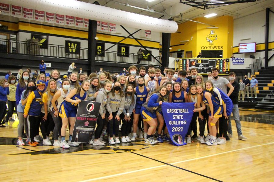 LOUD+AND+PROUD%0AThe+Eagles+Nest+joins+the+girls+basketball+team+as+they+pose+with+their+state+qualifier+banner.+