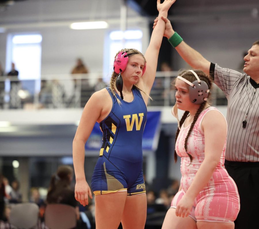 TRIUMPH. Avery Schmidt, ‘23, takes a win at the women’s regional wrestling meet on Jan. 27. Schmidt, wrestling at 170 lbs., and Ava Blue McDermott, wrestling at 120 lbs., will wrestle at the state tournament on Feb. 2 and 3 in Coralville. Schmidt hopes to end up on the podium, and the girls will be there to cheer each other on as she said “Sticking together and cheering for each other helped lead us to our success at regionals,” said Schmidt. (Sophie Bitter)